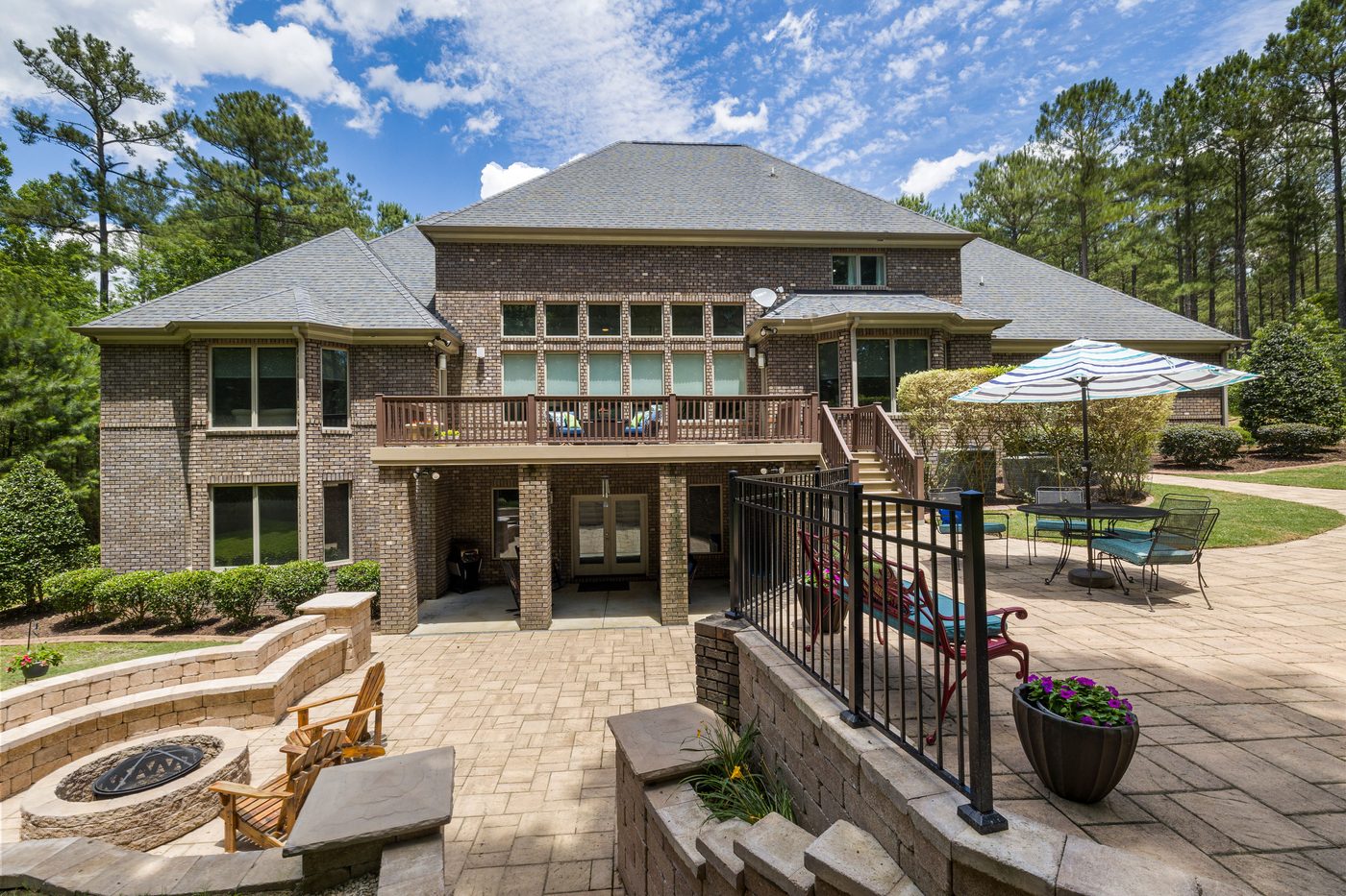 Large custom home exterior with brick facade and covered patio